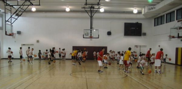 Coach demonstrating technique to a group of campers