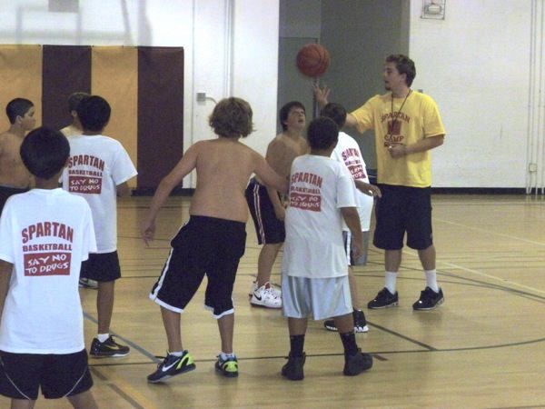 Camp counselor coaching a small group